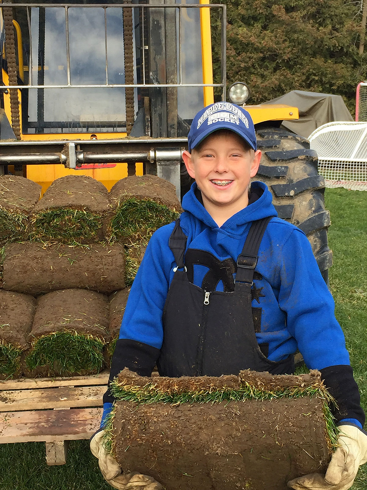 young boy holding sod
